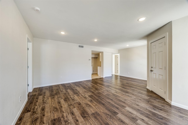 spare room with dark hardwood / wood-style flooring