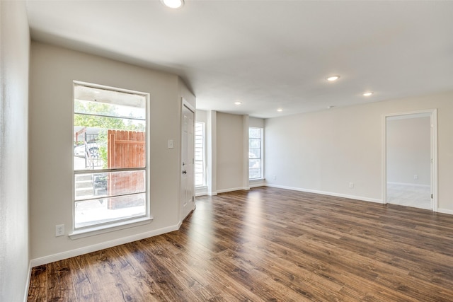 empty room with dark hardwood / wood-style flooring