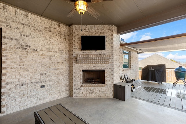 view of patio featuring an outdoor brick fireplace and a grill