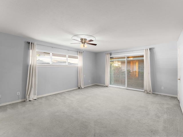 carpeted empty room with ceiling fan