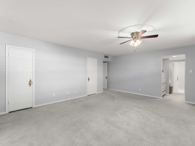 unfurnished room featuring ceiling fan and light carpet