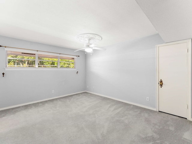 empty room featuring light colored carpet and ceiling fan