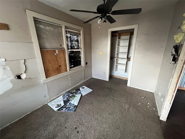 interior space with ceiling fan