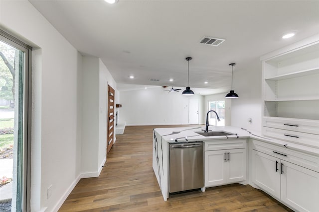 kitchen with white cabinets, dishwasher, wood-type flooring, and sink