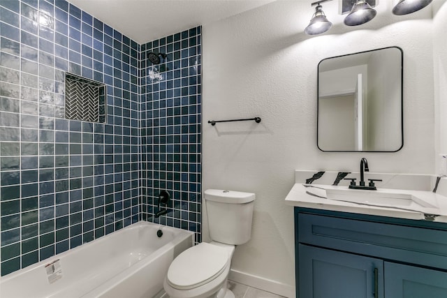 full bathroom with toilet, vanity, and tiled shower / bath