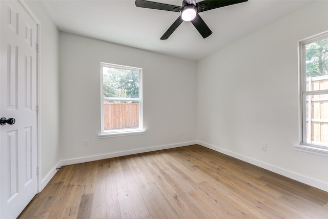 unfurnished room with ceiling fan, a wealth of natural light, and light hardwood / wood-style flooring