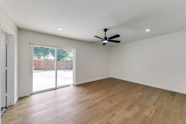 spare room featuring light wood-type flooring and ceiling fan