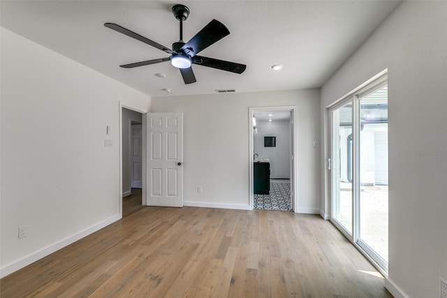 interior space featuring access to outside, light wood-type flooring, and ceiling fan