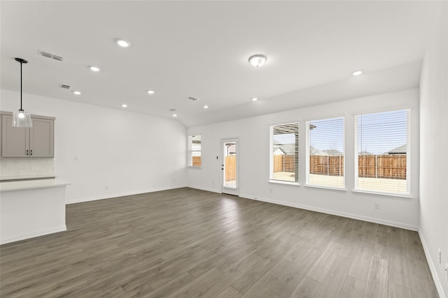 unfurnished living room with dark wood-type flooring