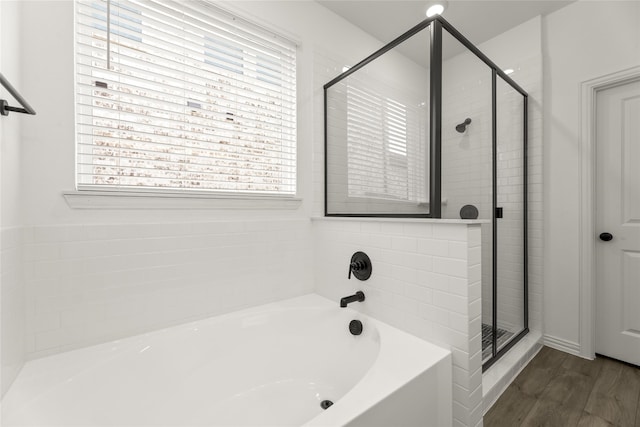 bathroom with shower with separate bathtub and hardwood / wood-style floors