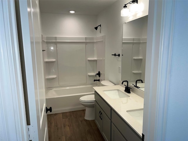 full bathroom with toilet, bathing tub / shower combination, vanity, and hardwood / wood-style flooring