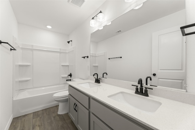 full bathroom featuring vanity, hardwood / wood-style floors,  shower combination, and toilet