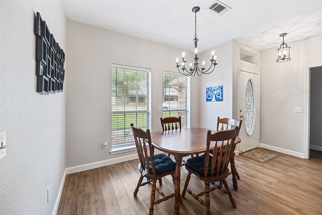 living room featuring light wood-type flooring and ceiling fan with notable chandelier