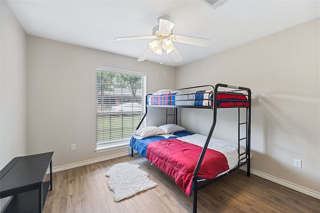 bedroom with ceiling fan and hardwood / wood-style flooring