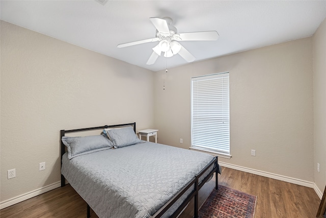 bedroom featuring dark hardwood / wood-style floors and ceiling fan