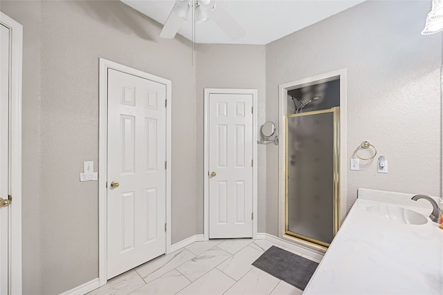 bathroom featuring vanity, ceiling fan, and walk in shower