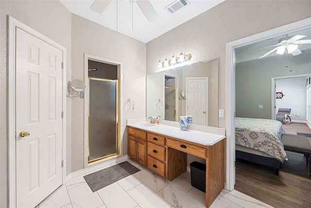 bathroom featuring ceiling fan, a shower with door, and vanity