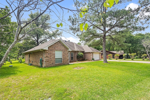 view of side of home featuring a lawn and a garage