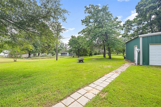 single story home featuring a garage and a front lawn