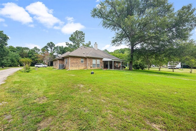 view of side of home featuring a lawn and a garage