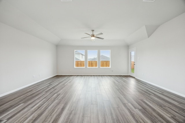 unfurnished room with wood-type flooring, lofted ceiling, and ceiling fan