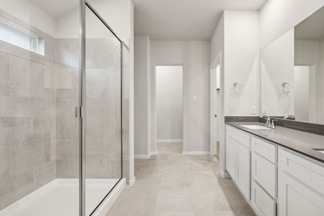 bathroom with vanity, an enclosed shower, and tile patterned floors