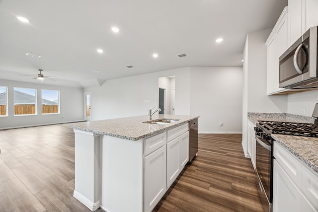 kitchen with white cabinetry, an island with sink, stainless steel appliances, and sink