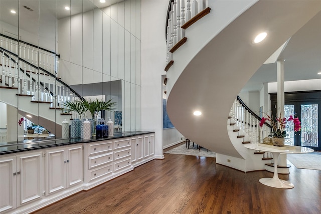 interior space featuring a high ceiling and hardwood / wood-style floors