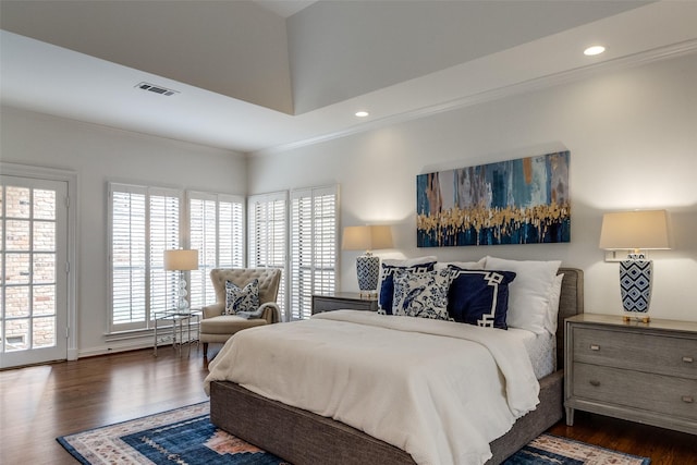 bedroom with dark hardwood / wood-style flooring and crown molding