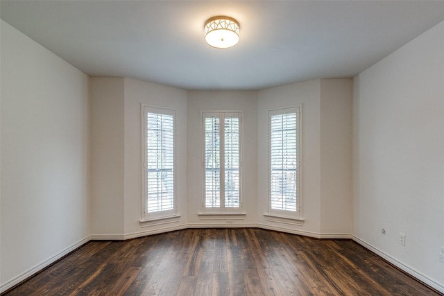 empty room featuring dark wood-type flooring