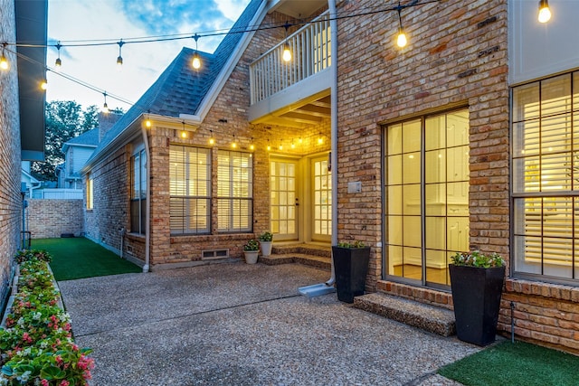 property entrance featuring a balcony and a patio