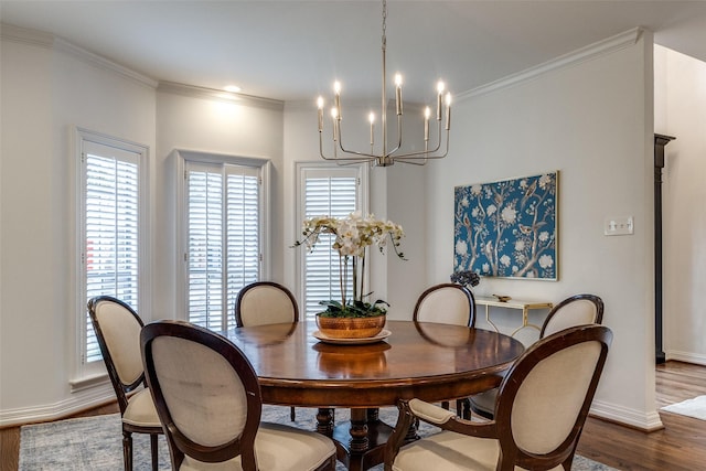 dining area with a notable chandelier, crown molding, and wood-type flooring