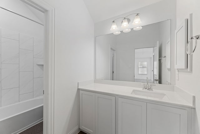 bathroom with vaulted ceiling, vanity, and bathtub / shower combination