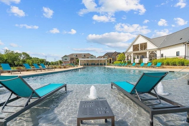 view of pool with pool water feature and a patio area