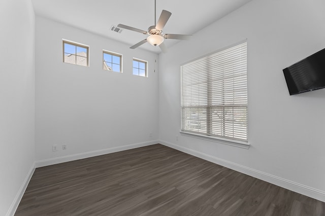 spare room featuring ceiling fan and dark hardwood / wood-style floors