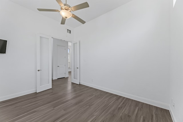 unfurnished bedroom featuring ceiling fan and dark hardwood / wood-style floors