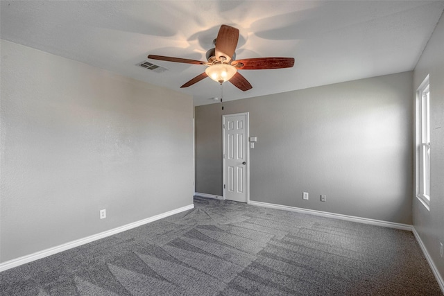 spare room featuring ceiling fan and carpet