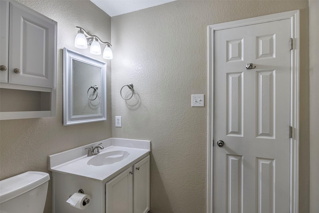 bathroom with toilet and vanity