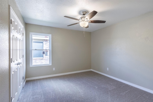 carpeted spare room with ceiling fan and a textured ceiling