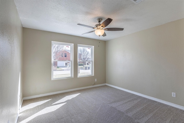 carpeted empty room with a textured ceiling and ceiling fan