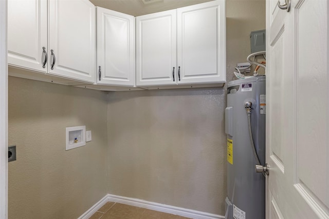 clothes washing area featuring electric dryer hookup, washer hookup, cabinets, light tile patterned flooring, and water heater