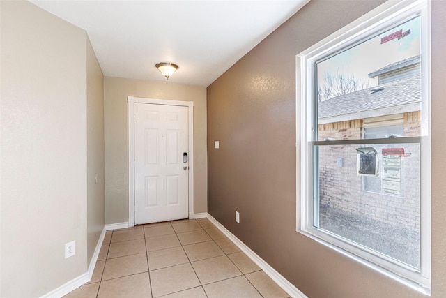 doorway with light tile patterned floors