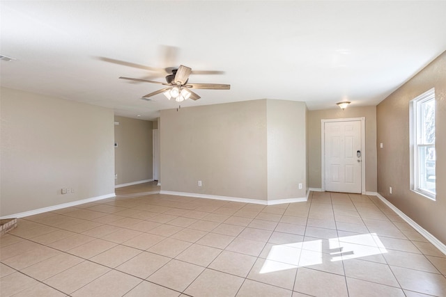 empty room featuring ceiling fan and light tile patterned floors