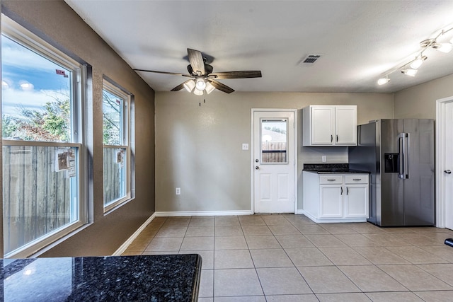 kitchen with ceiling fan, stainless steel fridge with ice dispenser, white cabinetry, and light tile patterned flooring