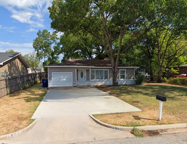 view of front of property with a garage and a front yard