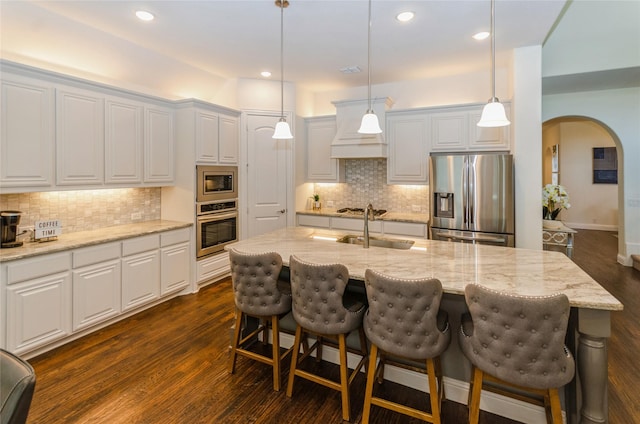 kitchen with sink, a center island with sink, white cabinets, and appliances with stainless steel finishes