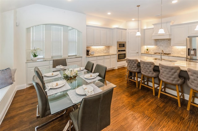 dining room with dark wood-type flooring and sink