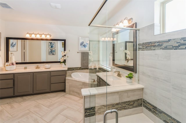 bathroom featuring tile patterned flooring, independent shower and bath, and vanity