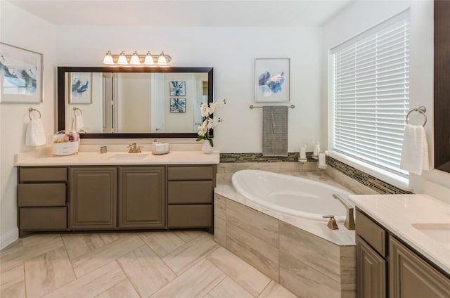 bathroom with vanity, tile patterned floors, and tiled bath