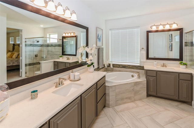 bathroom featuring tile patterned flooring, independent shower and bath, and vanity